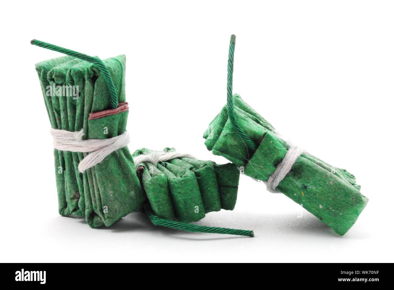 green firecracker isolated on white background showing new year concept