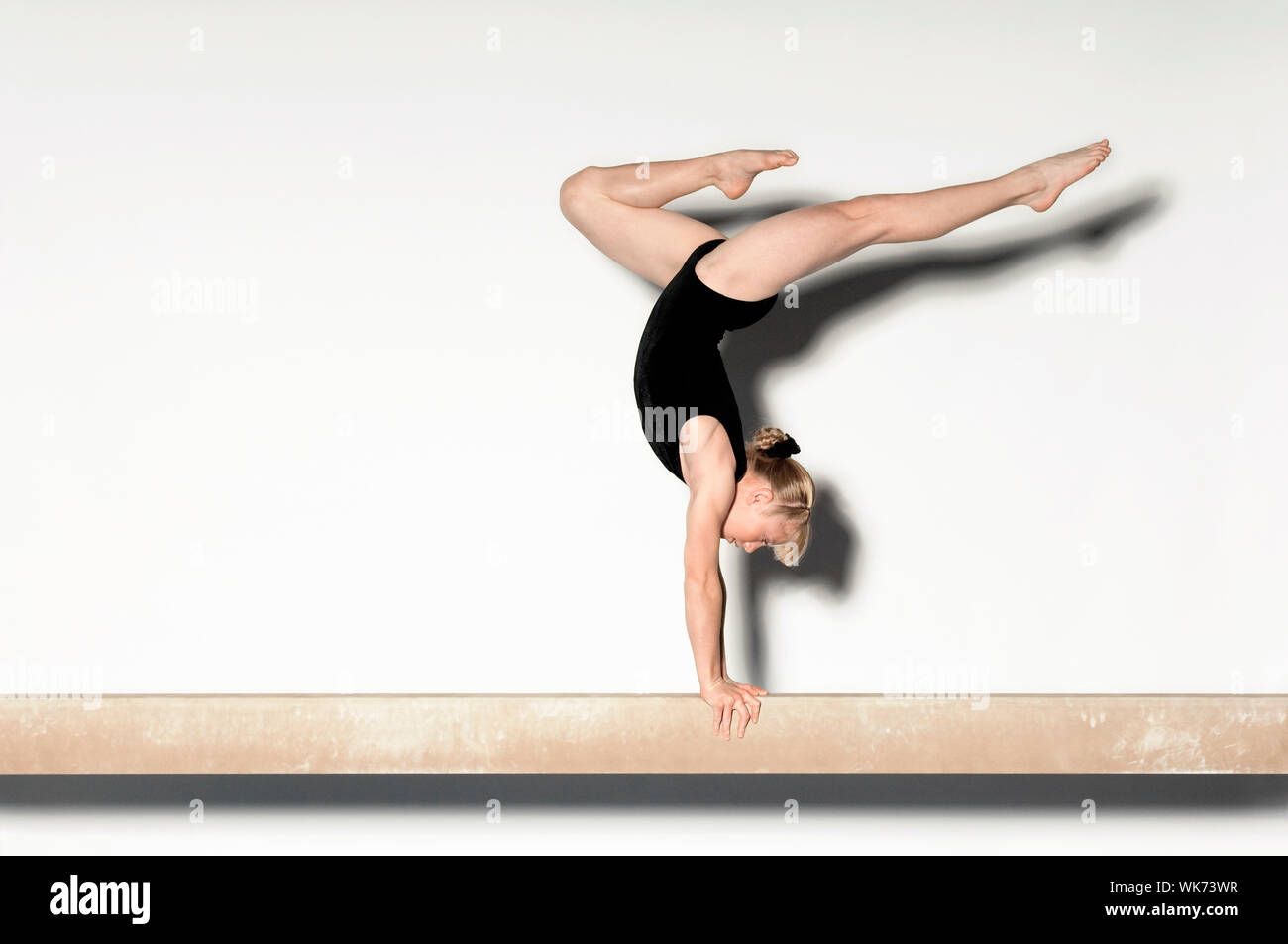 Young Gymnast Doing Handstand on Balance Beam Stock Photo Alamy