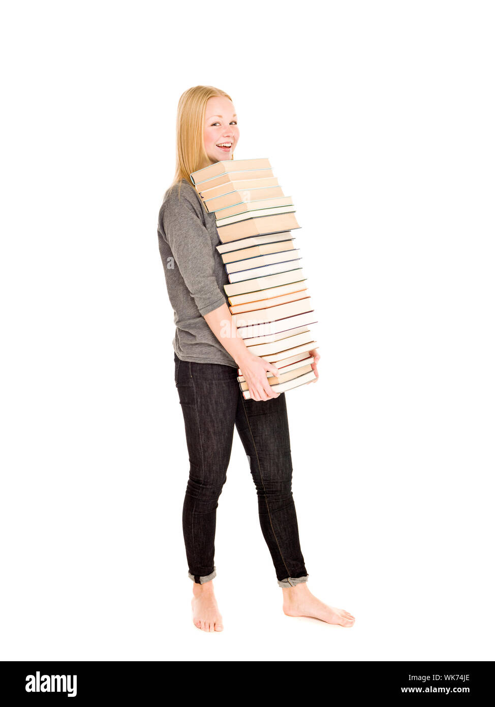 Young girl carrying a pile of books isolated on white background Stock ...
