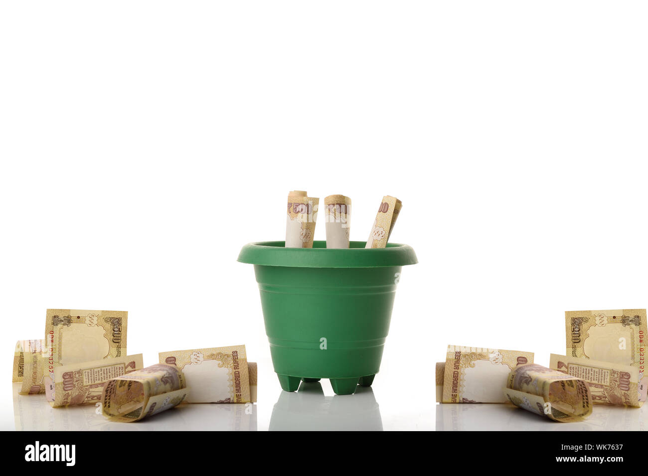 Money growing in a pot Stock Photo