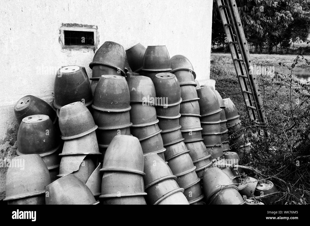 Stacked Empty Flower Pots On Wall Stock Photo - Alamy
