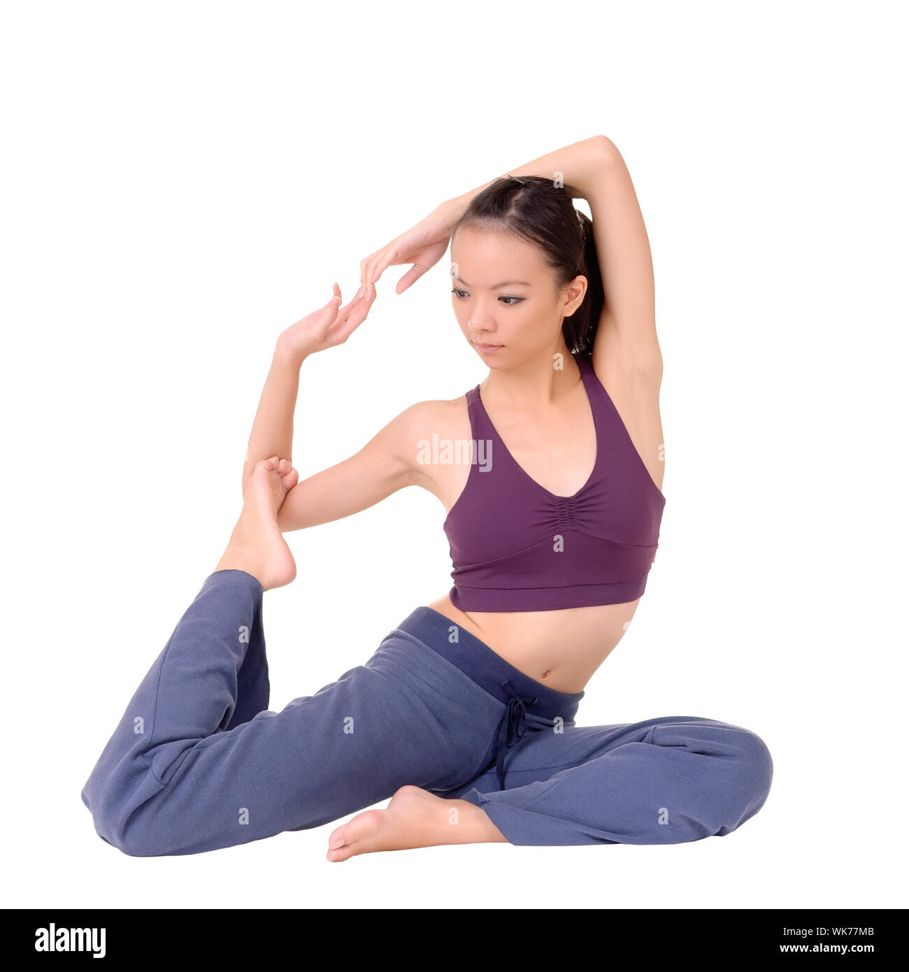 Young Asian woman doing expert yoga exercise isolated over white Stock ...