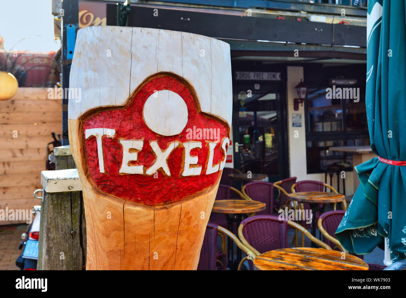 De Koog,  Netherlands - August 2019: Large wooden replica of a beer mug as advertisement for local beer brand called 'Texlers' on island Texel Stock Photo