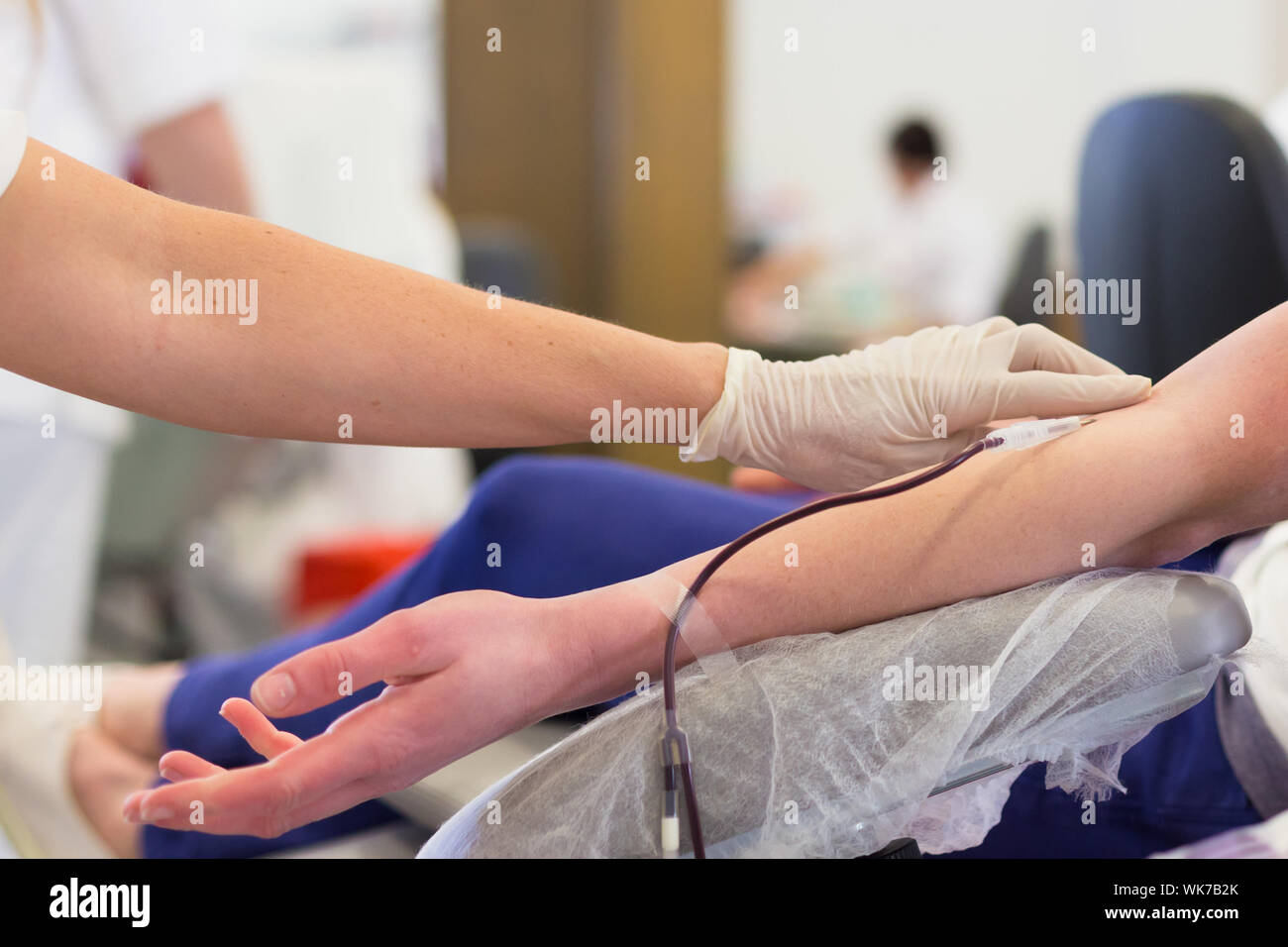Nurse and blood donor at donation. Stock Photo