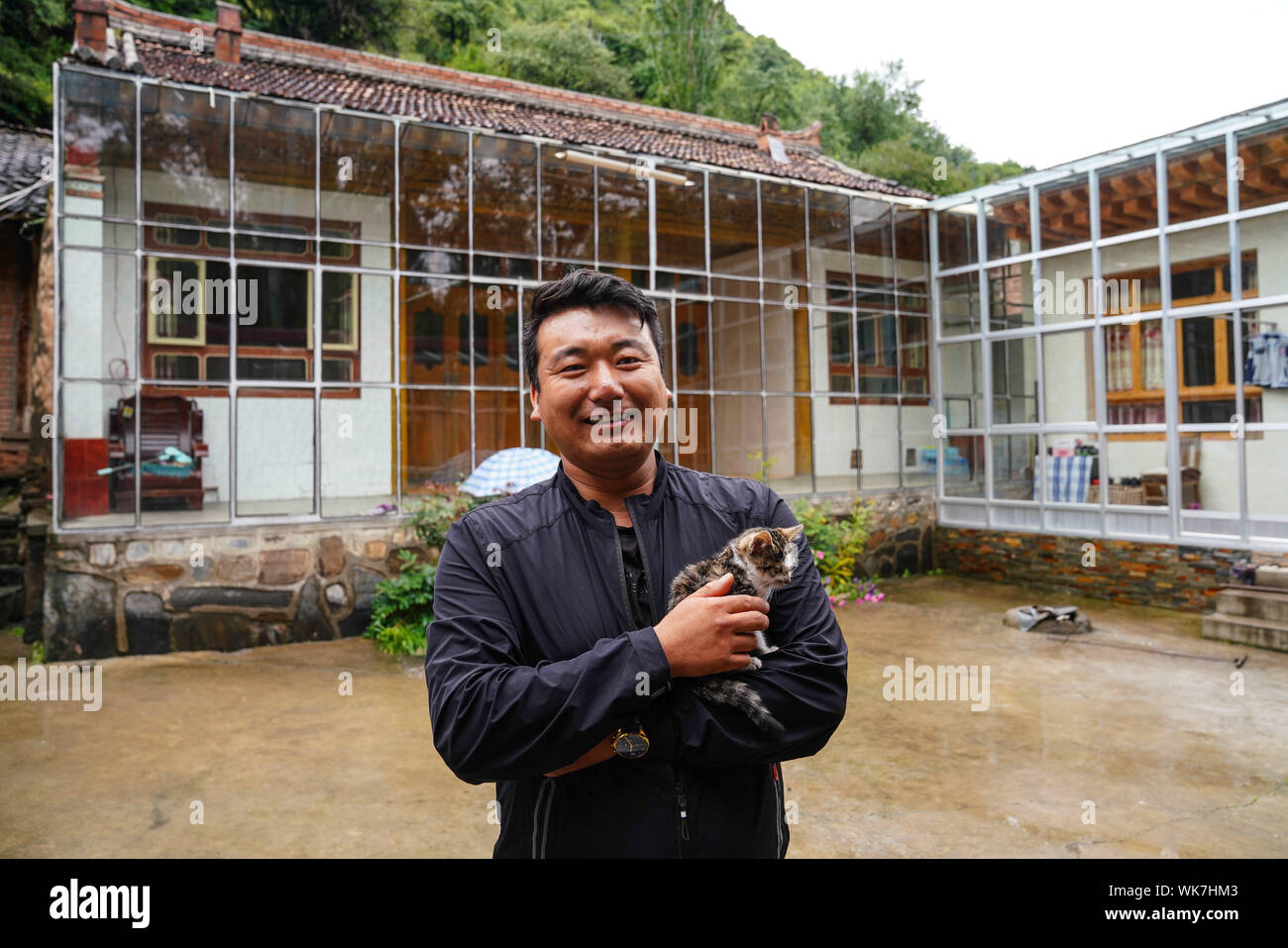 Lanzhou. 28th Aug, 2019. Photo taken on Aug. 28, 2019 shows a villager standing in front of his glassing house to be used as a farm stay in Xianggao Village, Gannan Tibetan Autonomous Prefecture of northwest China's Gansu Province. Official data showed that China lifted 13.86 million people in rural areas out of poverty in 2018, with the number of impoverished rural residents dropping from 98.99 million in late 2012 to 16.6 million by the end of last year. Credit: Chen Junqing/Xinhua/Alamy Live News Stock Photo