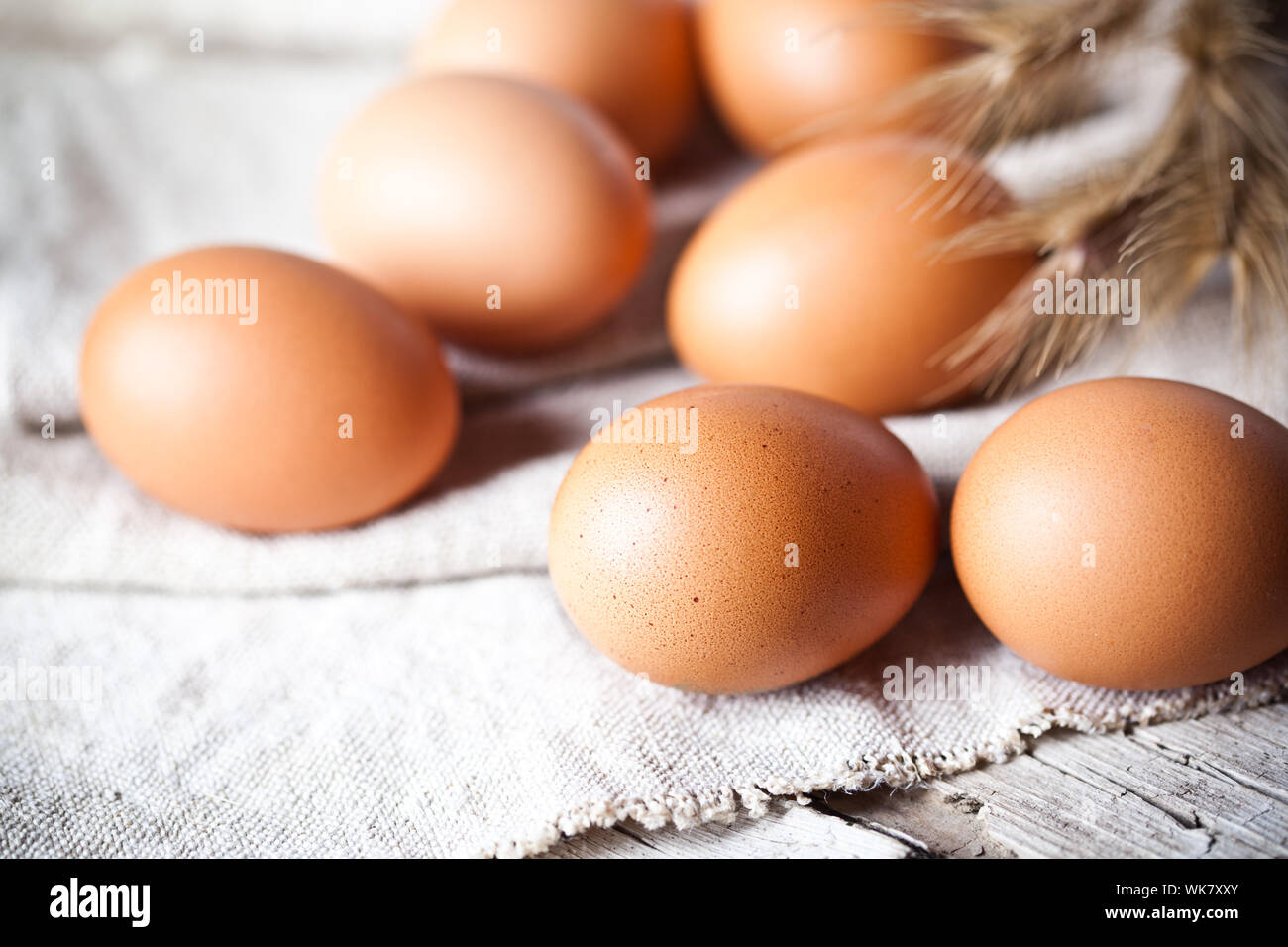 fresh brown eggs and wheat ears on linen background Stock Photo Alamy