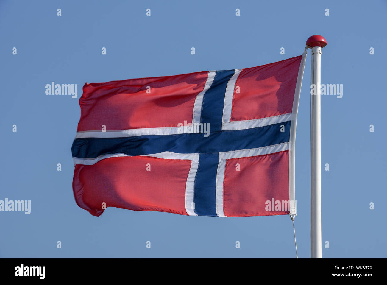 Norwegian flag waving on the wind against blue sky Stock Photo - Alamy