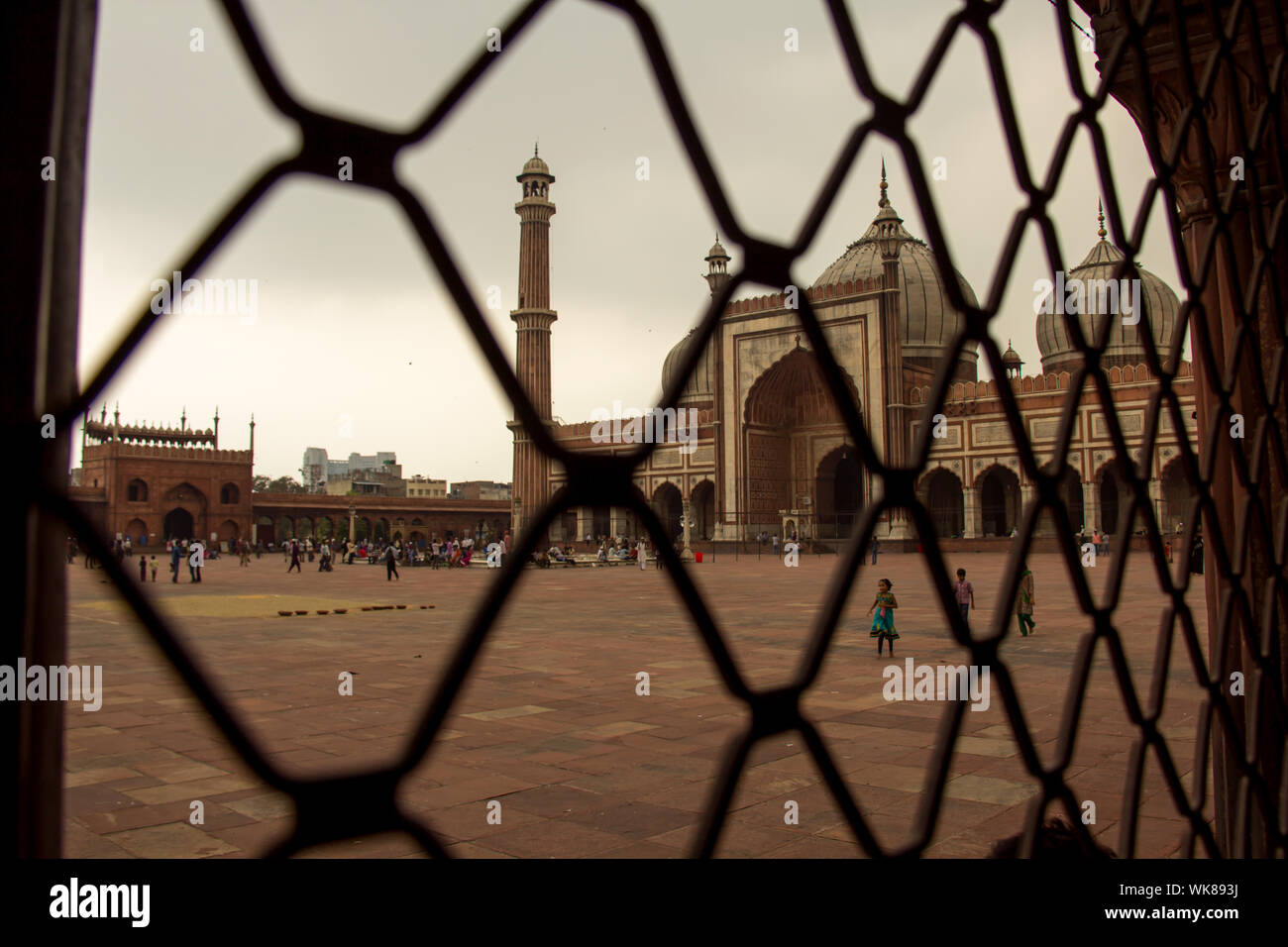 People at a mosque viewed through a chainlink fence, Jama Masjid, Old  Delhi, India Stock Photo - Alamy