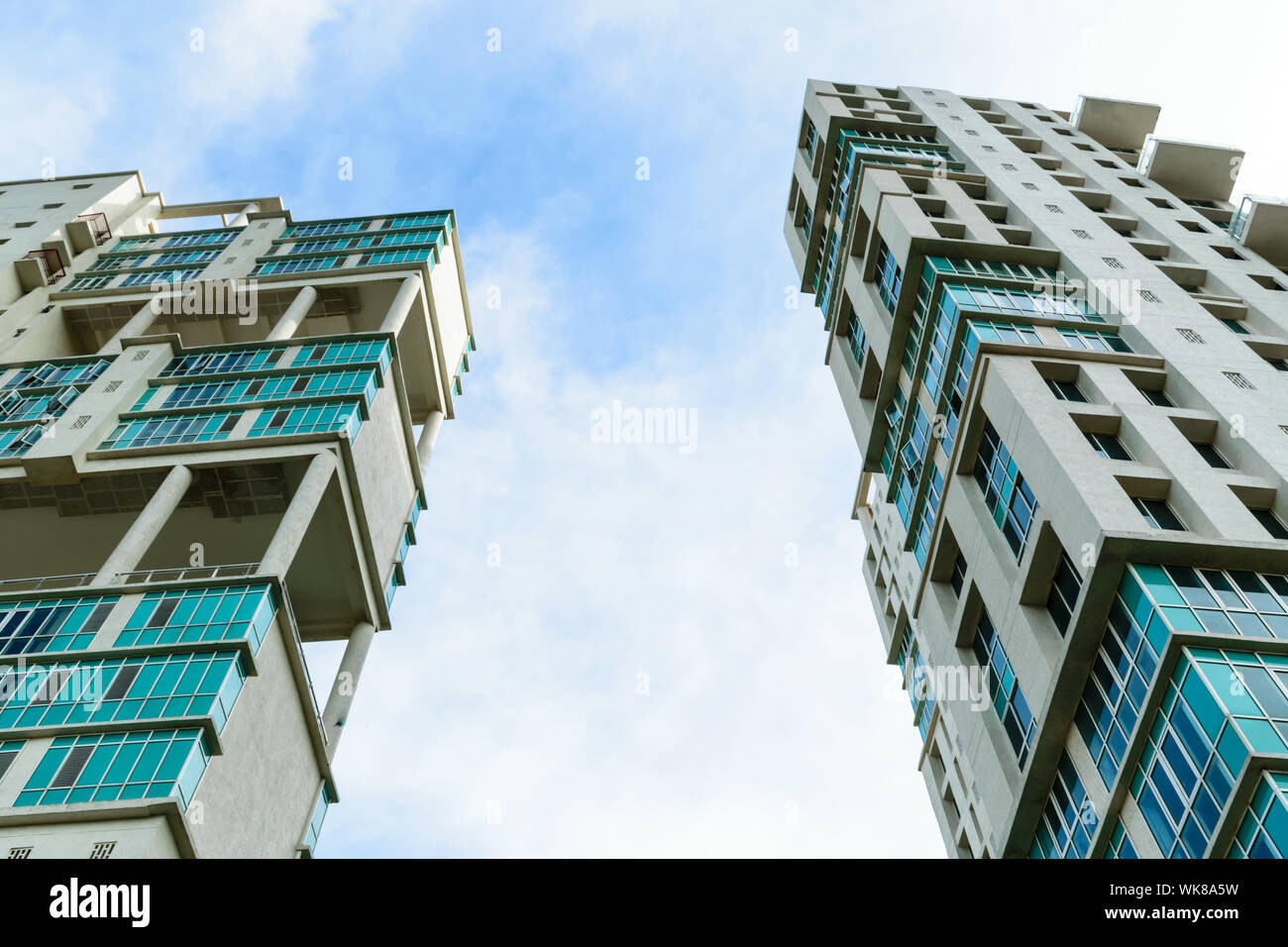 Low angle view of Modern skyscrapers Buildings in Kolkata City. Sunlight reflection, blue sky and white Fluffy clouds during sunset. Directly below vi Stock Photo
