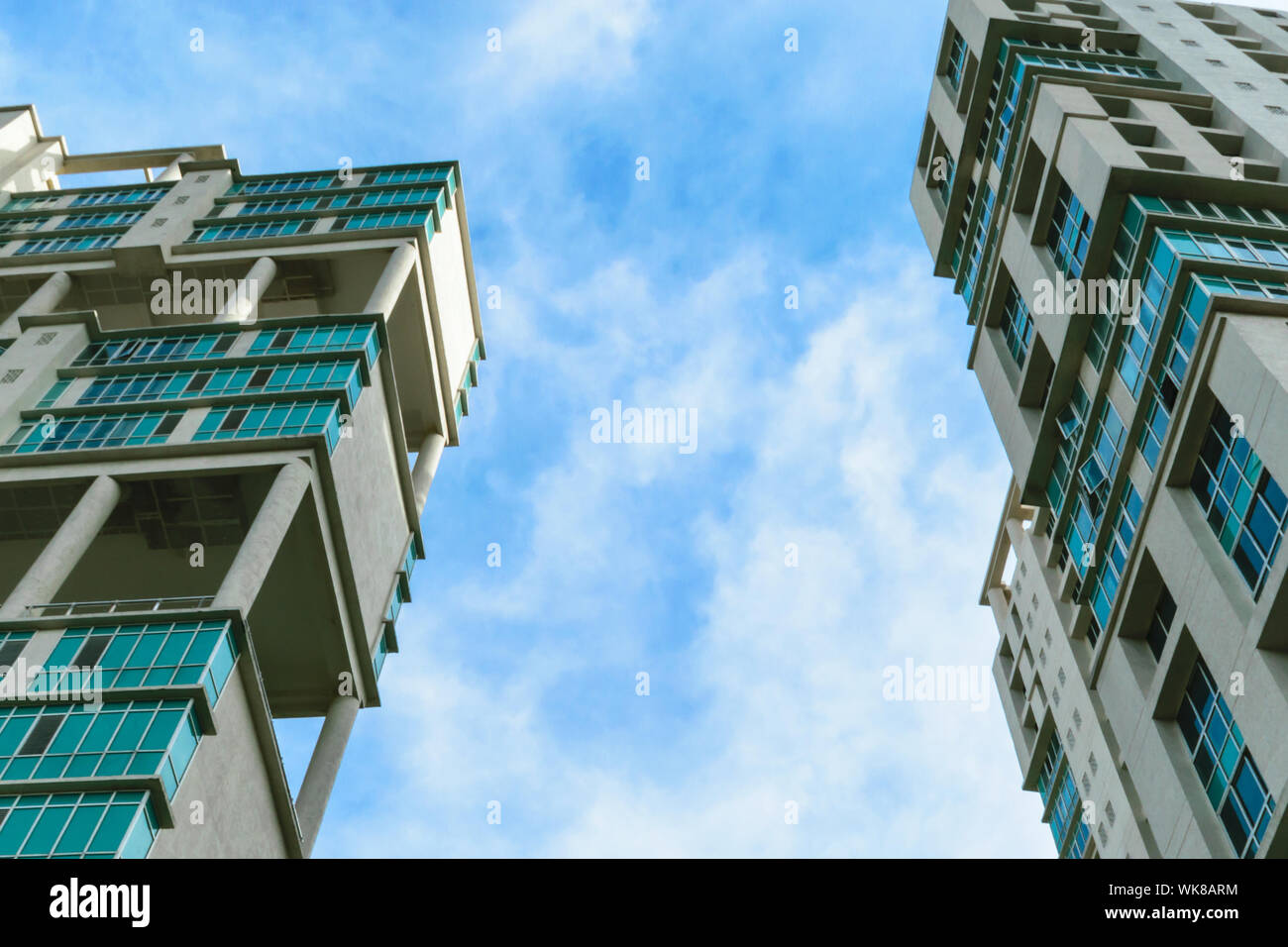 Low angle view of Modern skyscrapers Buildings in Kolkata City. Sunlight reflection, blue sky and white Fluffy clouds during sunset. Directly below vi Stock Photo