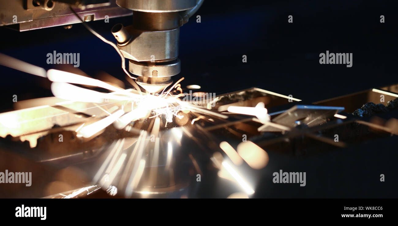 Laser metall cut cnc machine. Fly fire sparks background. Stock Photo