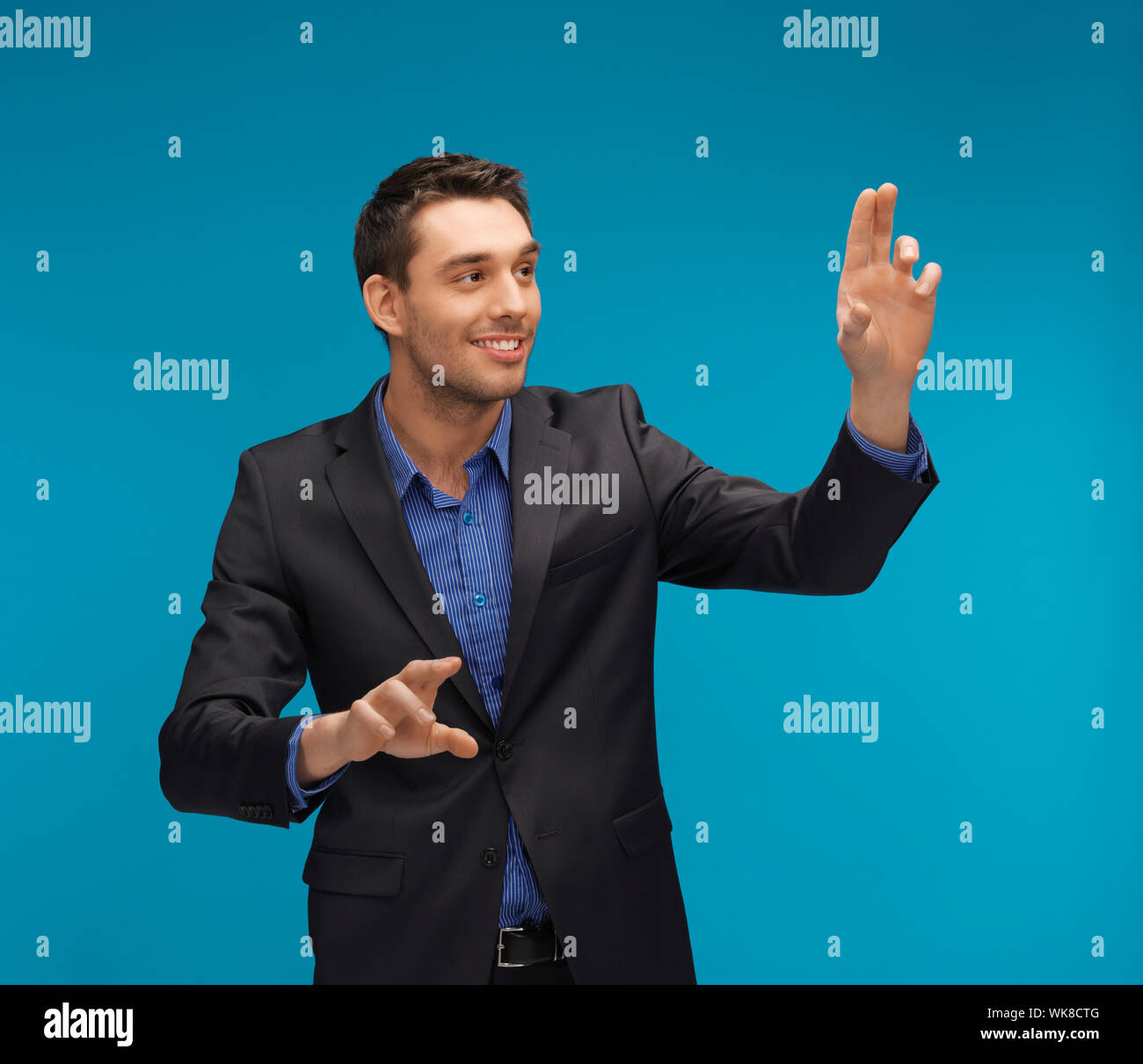 man in suit working with something imaginary Stock Photo