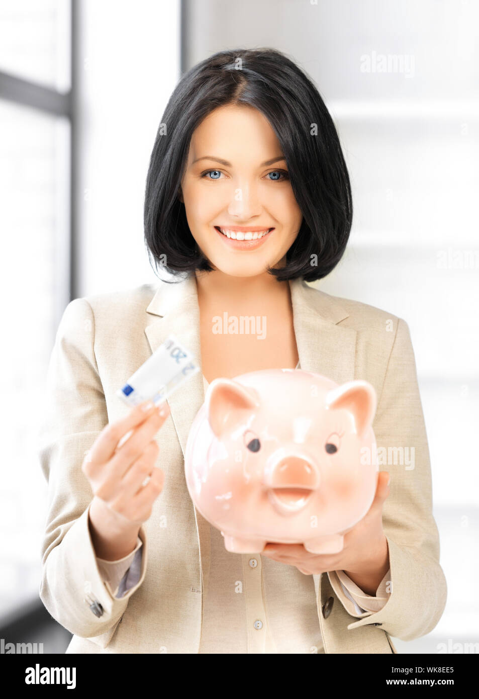 lovely woman with piggy bank and money Stock Photo - Alamy
