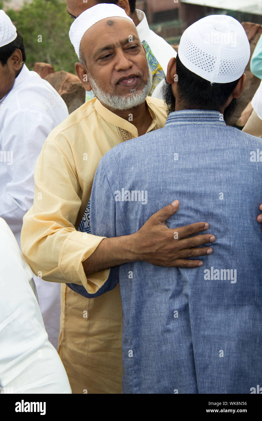 Muslim men hugging to each other, Jama Masjid, Old Delhi, India Stock Photo