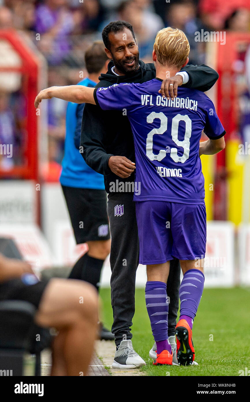 01 September 2019, Lower Saxony, Osnabrück: Soccer: 2nd Bundesliga, VfL Osnabrück - Karlsruher SC, Matchday 5: Osnabrück coach Daniel Thioune (left) embraces Osnabrück's Bryan Henning after his first appearance at the VfL. Photo: David Inderlied/dpa - IMPORTANT NOTE: In accordance with the requirements of the DFL Deutsche Fußball Liga or the DFB Deutscher Fußball-Bund, it is prohibited to use or have used photographs taken in the stadium and/or the match in the form of sequence images and/or video-like photo sequences. Stock Photo
