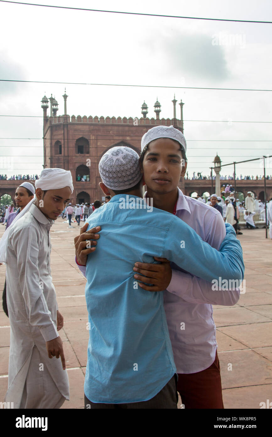 Muslim people hugging to each other, Jama Masjid, Old Delhi, India Stock Photo