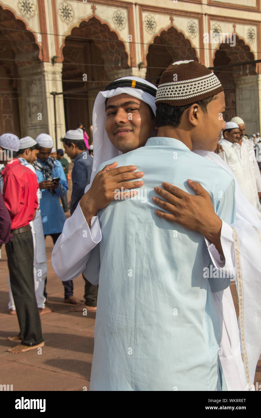 Muslim men hugging to each other, Jama Masjid, Old Delhi, India Stock Photo