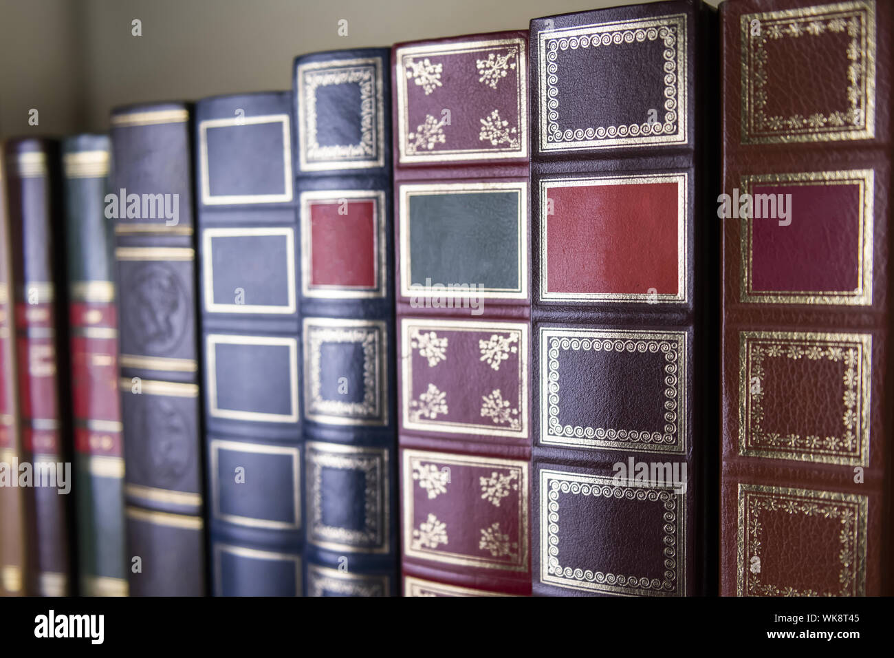 Books in classic covers are on the bookshelf , selective focus Stock Photo