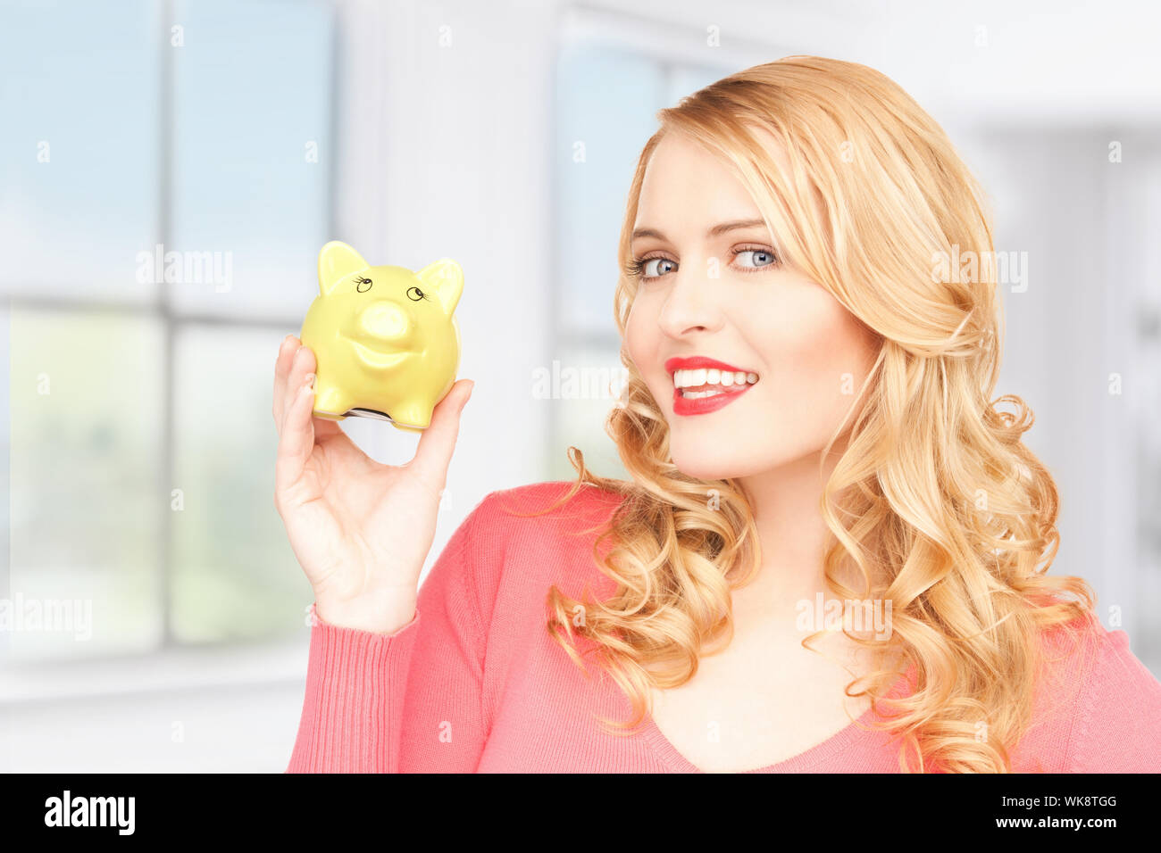 picture of lovely woman with piggy bank Stock Photo - Alamy