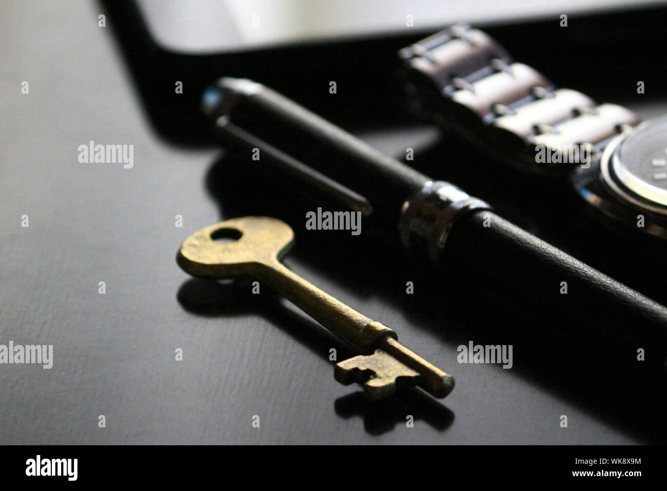 Still life of antique brass keys and cool male belongings Stock Photo