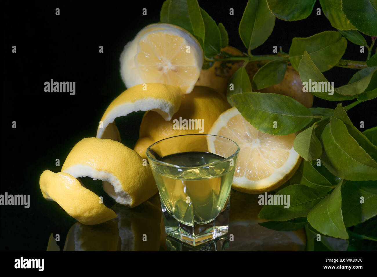 Traditional homemade lemon liqueur limoncello and fresh citrus on the