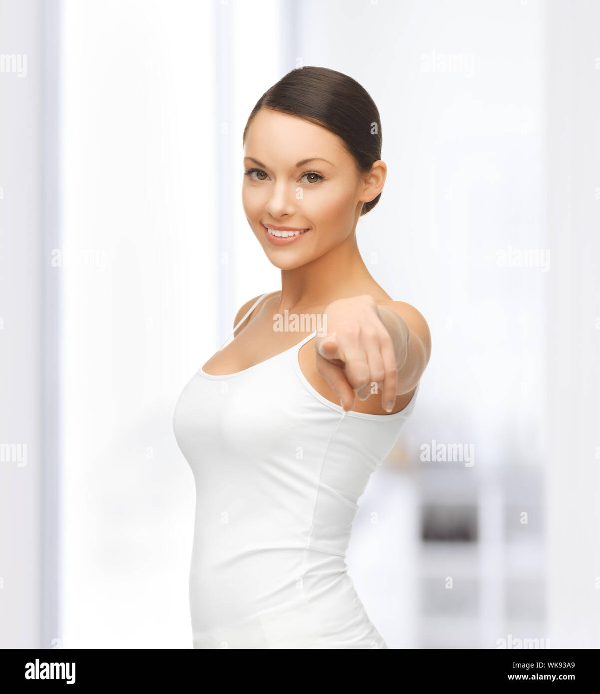 happy woman in blank white tshirt pointing at you Stock Photo Alamy