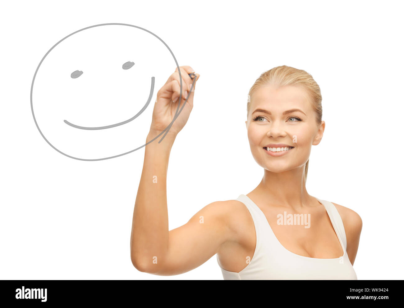 smiling woman in white shirt drawing happy smile on glass Stock Photo