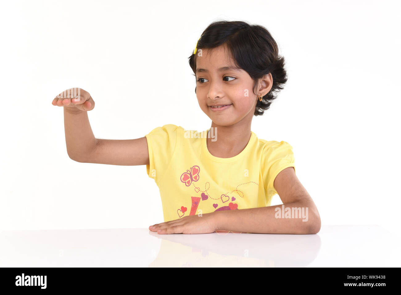 Girl pretending to size Stock Photo