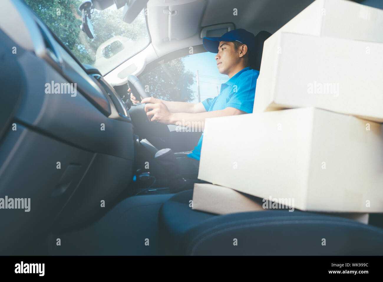 Side view young delivery man hi-res stock photography and images - Alamy