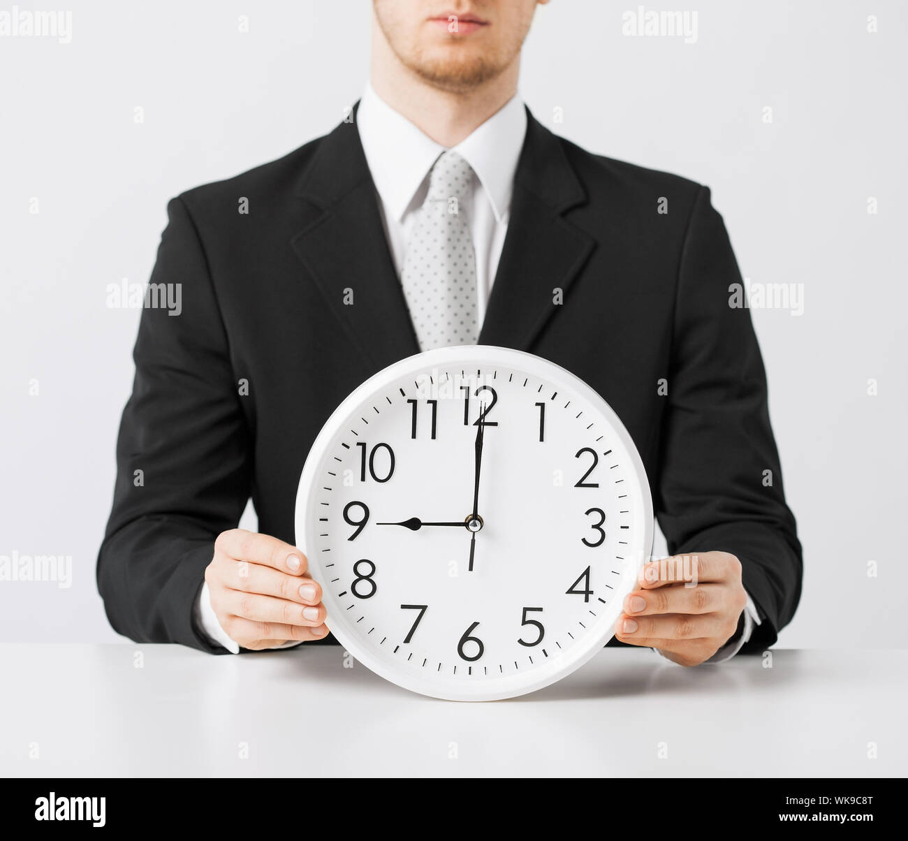 man with wall clock Stock Photo