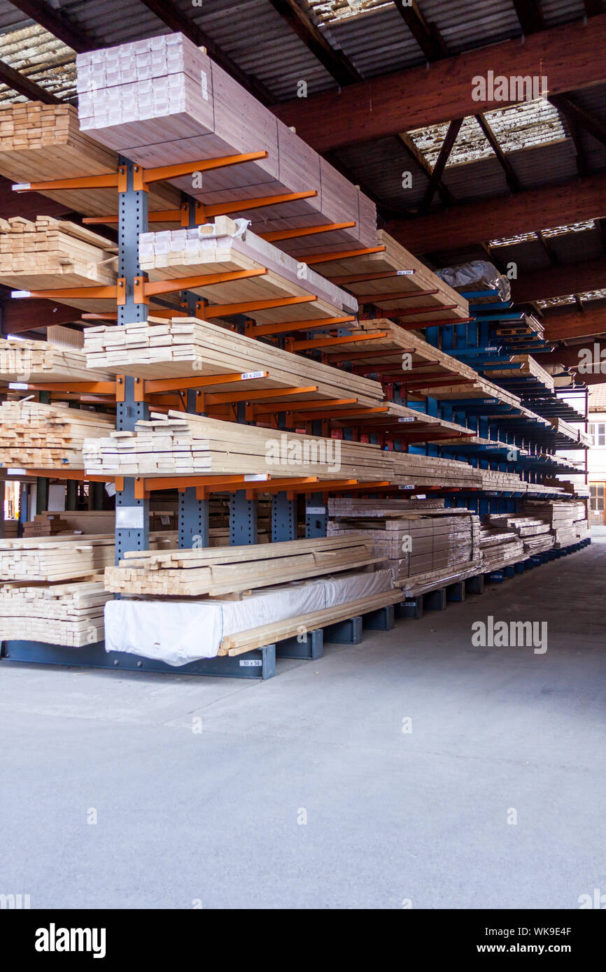Wooden panels stored inside an industrial warehouse on metal shelving ...