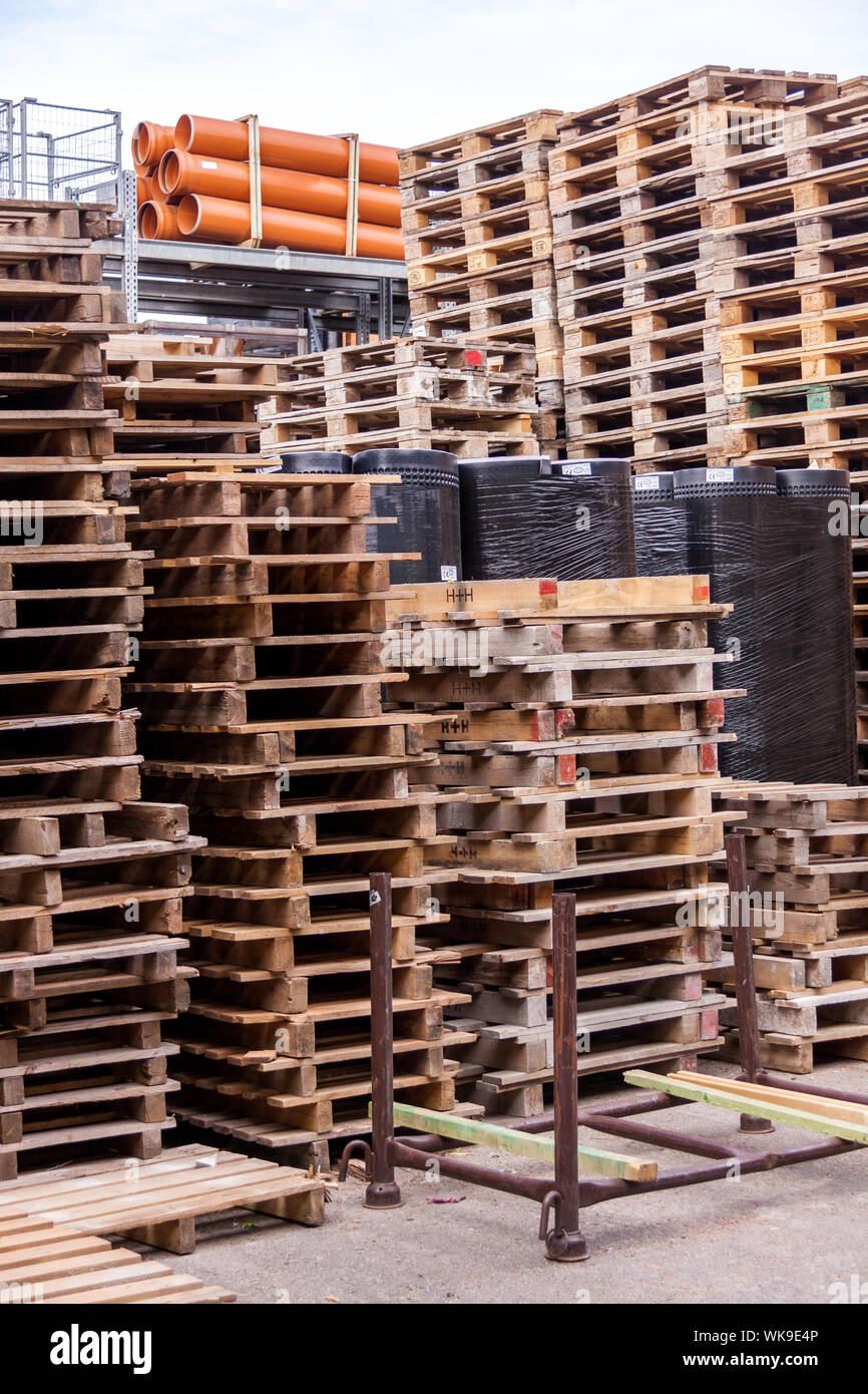 Stacks of old wooden pallets in a commercial or industrial yard used