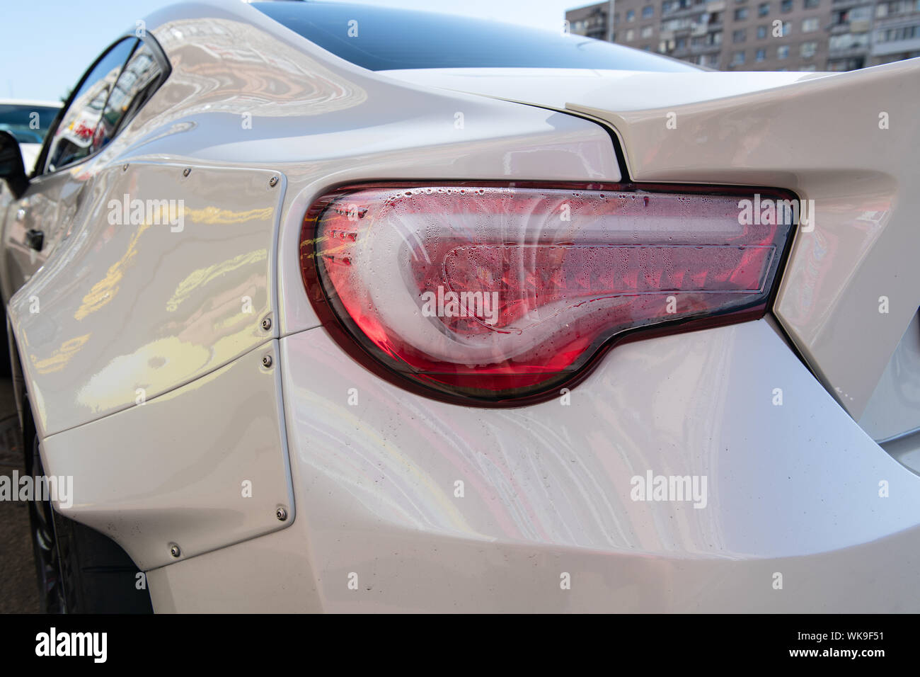 White sports car closeup. Problems with rear lights. Fogged up backlight. Condensation in taillights. Repairs needed. Stock Photo