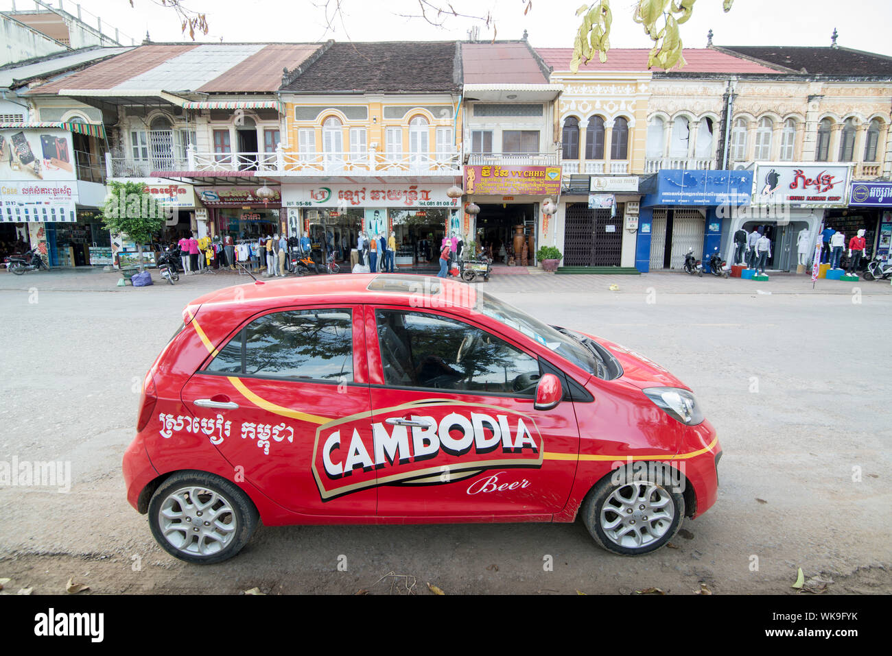 a car of the Cambodia beer company in front of Colonial Buildings at