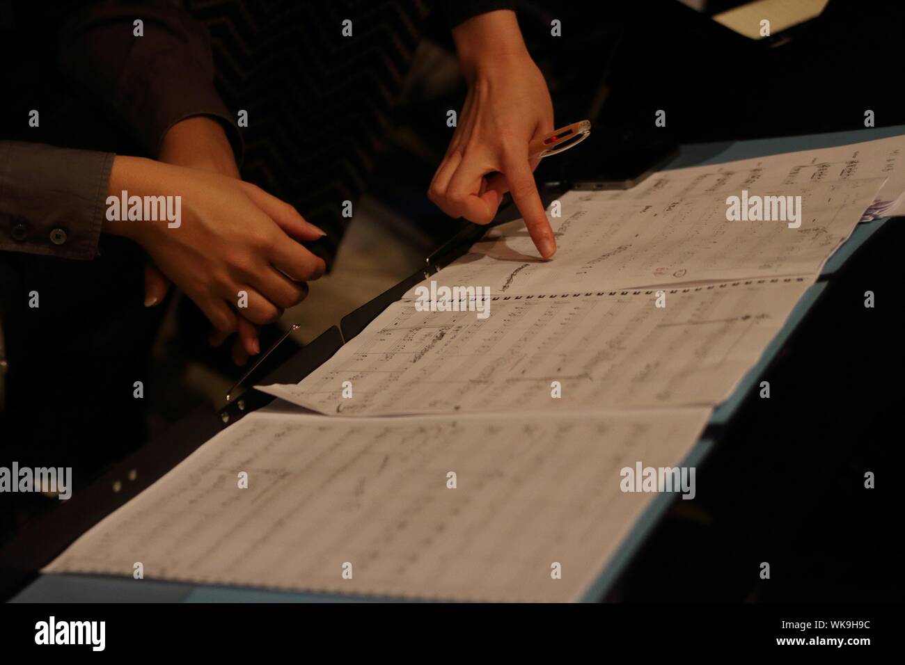 Cropped Hands Of Women Composing Music Notes Stock Photo