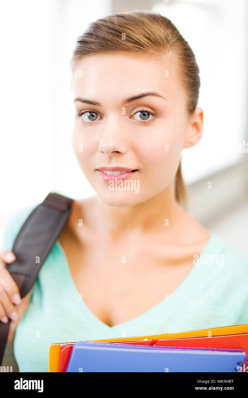 happy student girl with school bag and color folders Stock Photo - Alamy