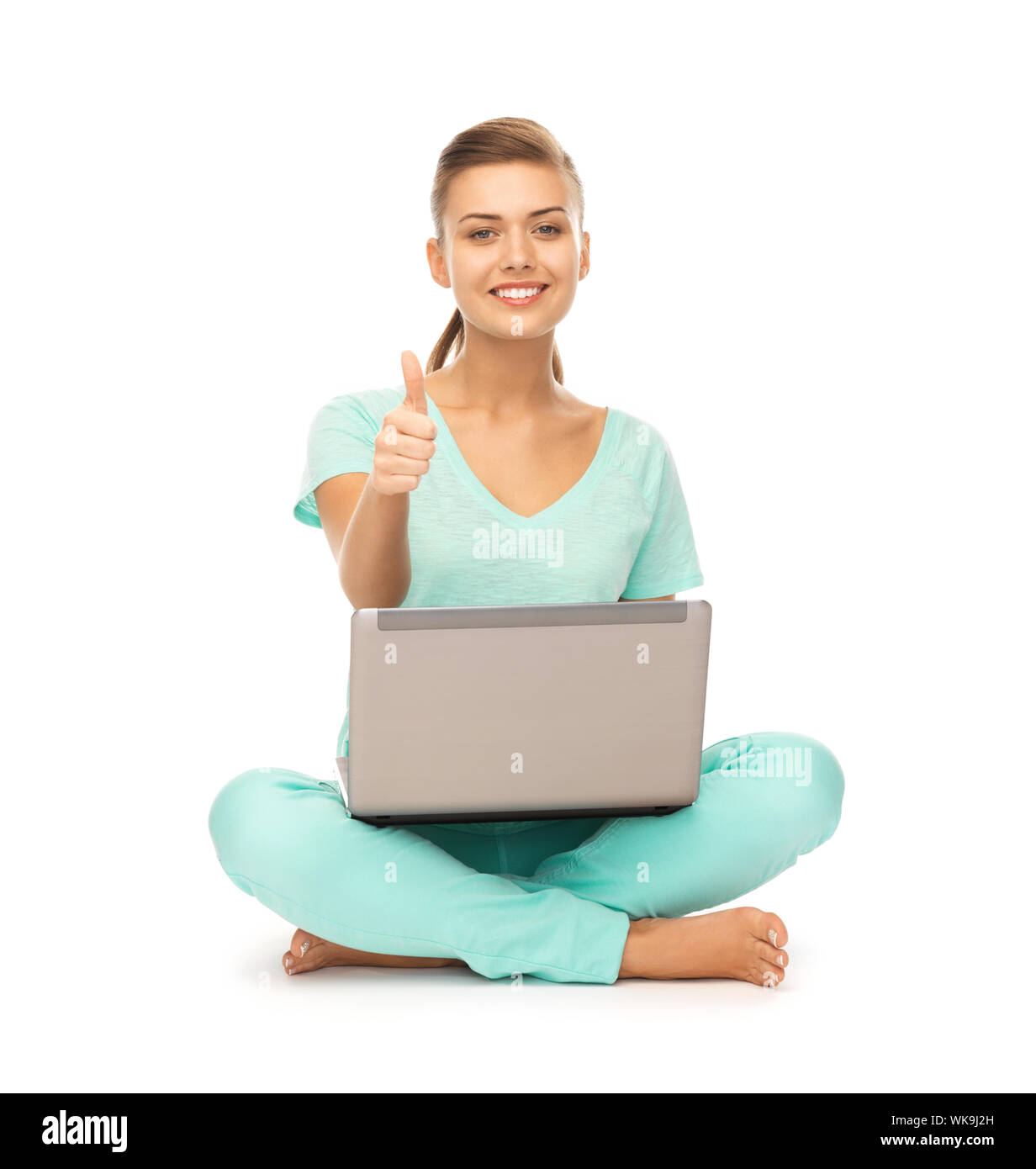 young girl sitting on the floor with laptop showing thumbs up Stock ...
