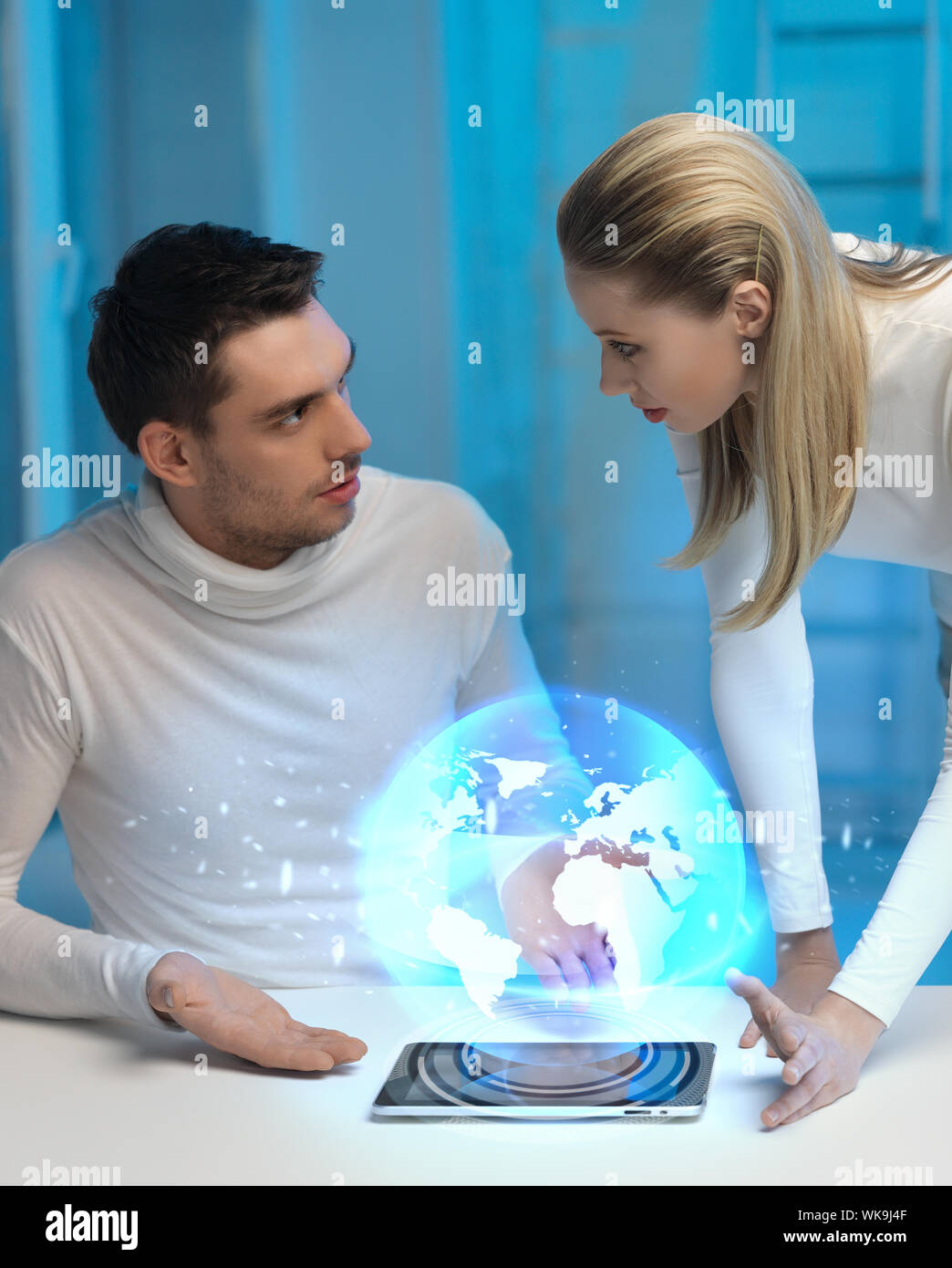 futuristic man and woman with globe hologram Stock Photo