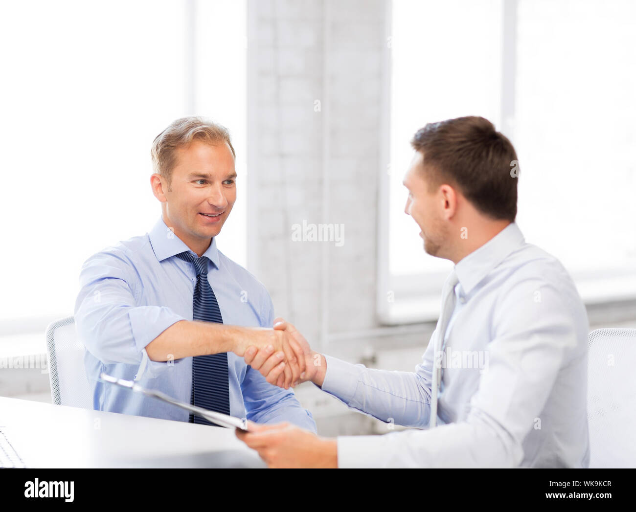 picture of businessmen shaking hands in office Stock Photo