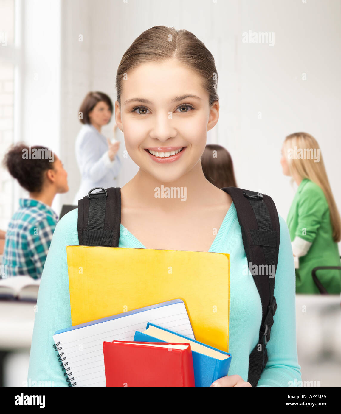 happy student girl with school bag and notebooks at school Stock Photo ...