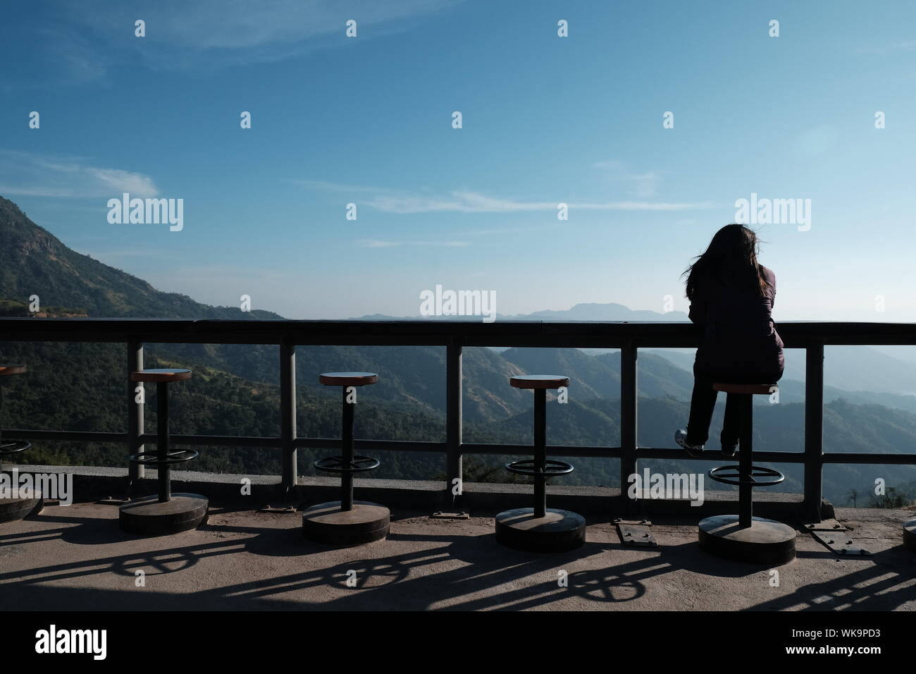 Person sitting on a stool hi-res stock photography and images - Alamy