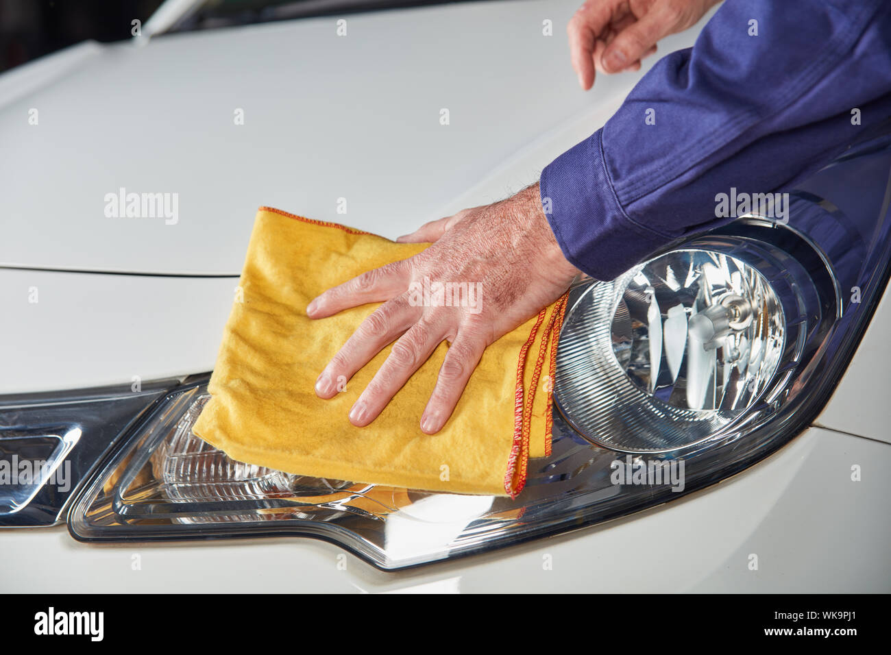 Mechanic hand with cloth while brushing and polishing to paint care of