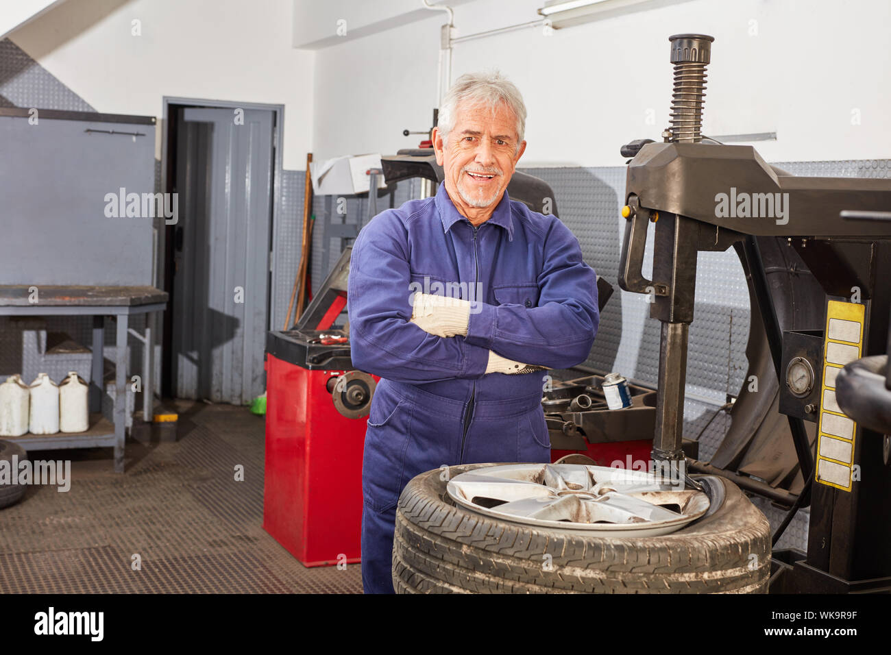 Senior as a boss and master in the auto repair shop or garage while hooping Stock Photo
