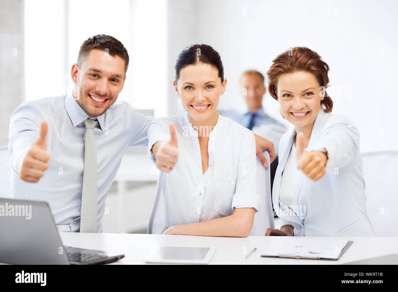 business team showing thumbs up in office Stock Photo - Alamy