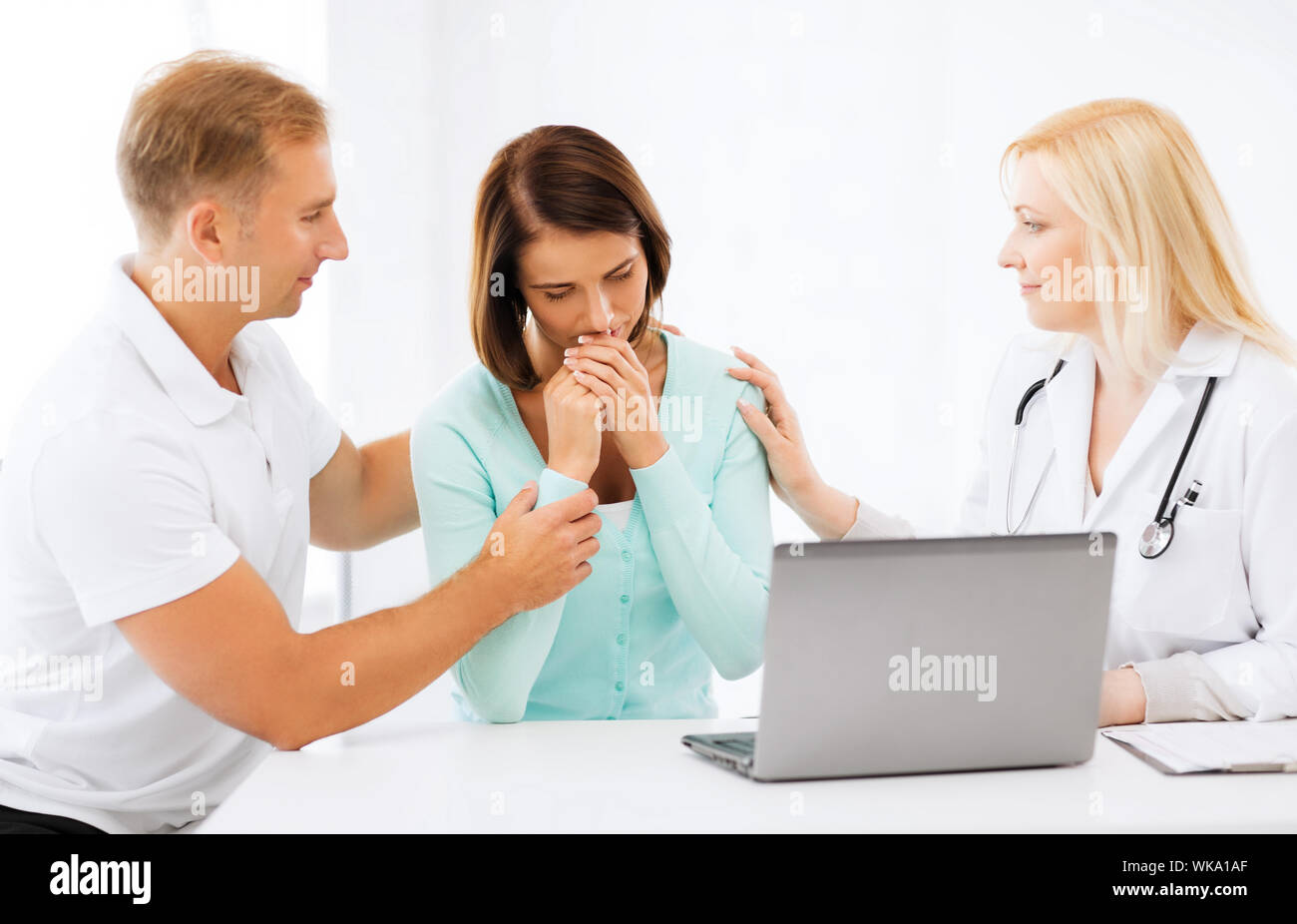 Doctor young couple crying sad hi-res stock photography and images - Alamy