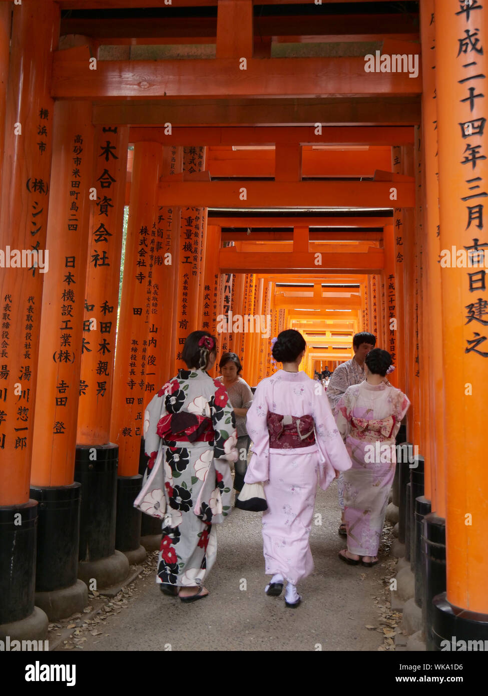 JAPAN - photo by Sean Sprague  Kyoto. Fushimi Inari-Taishi shrine with its vermilion torii (gates). Japanese wearing tradional kimono. Stock Photo