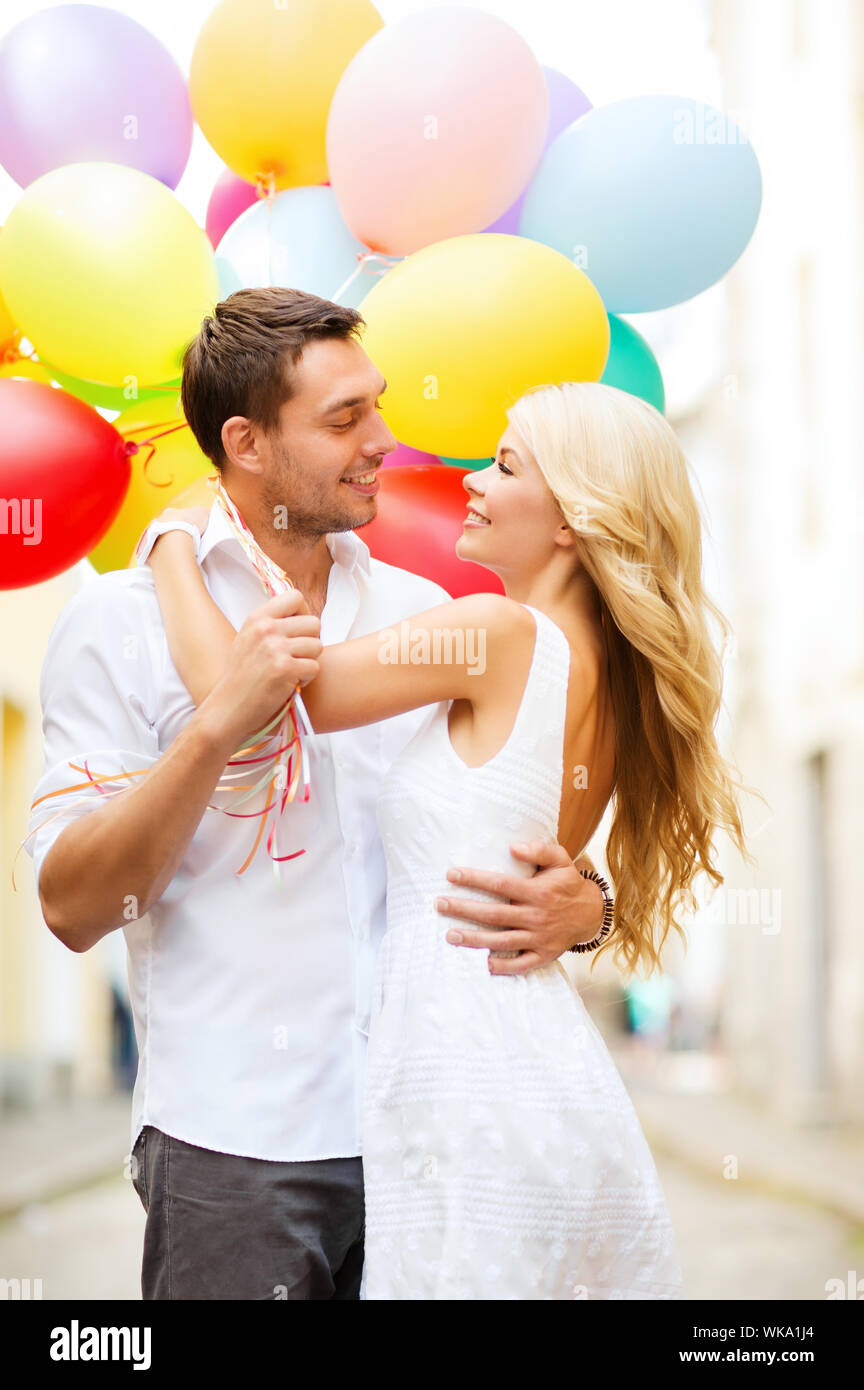 couple with colorful balloons kissing in the park Stock Photo - Alamy