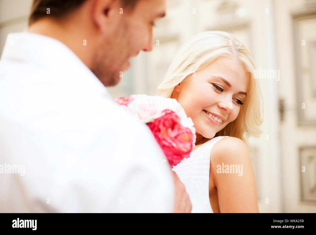Happy couple present flowers hi-res stock photography and images - Alamy