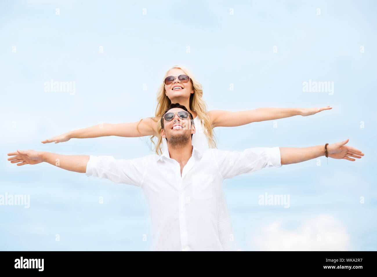 couple holding hands up at sea side Stock Photo - Alamy