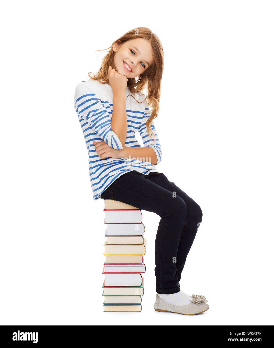 little student girl sitting on stack of books Stock Photo - Alamy